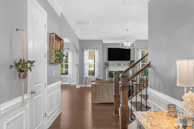 a view of a livingroom with wooden floor and a flat screen tv