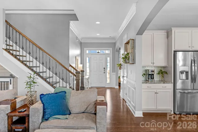 a living room with furniture and a dining table