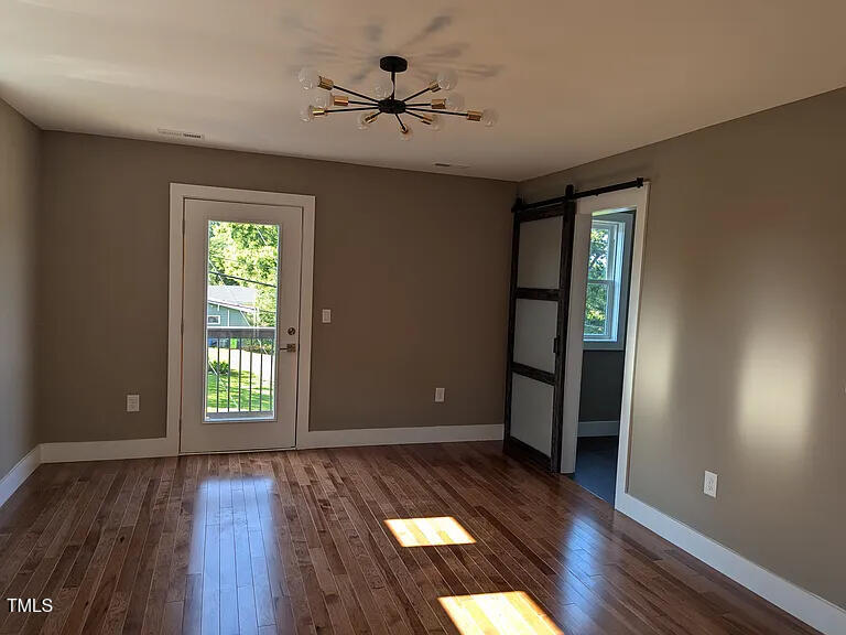 169 Prospect Avenue Raleigh, NC 27603 - Photo 11 of 23 wooden floor in an empty room with a window