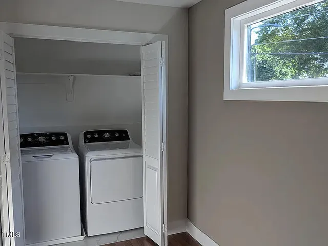 a bathroom with a sink toilet vanity and window