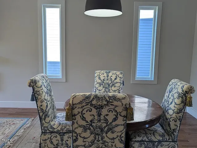 a view of a dining room with furniture and window