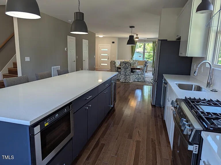 169 Prospect Avenue Raleigh, NC 27603 - Photo 7 of 23 a kitchen with sink stove and cabinets