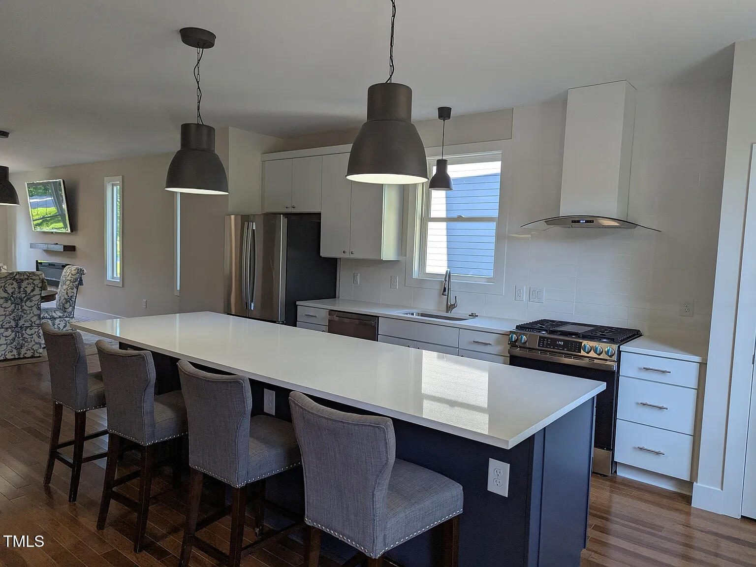 169 Prospect Avenue Raleigh, NC 27603 - Photo 10 of 23 a kitchen with stainless steel appliances a dining table chairs and stove top oven