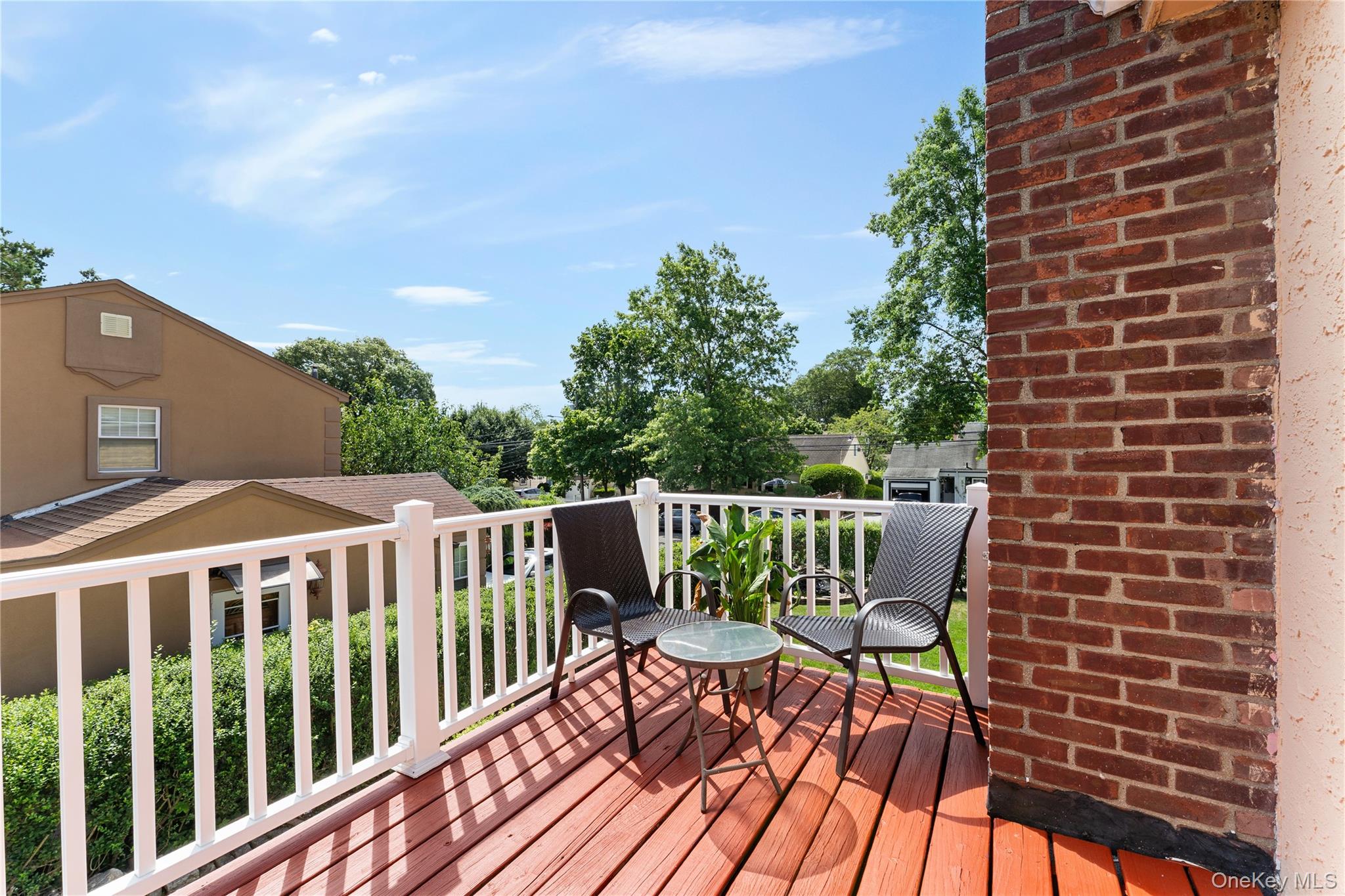7 Mayfair Road Baldwin, NY 11510 - Photo 13 of 27 a view of a roof deck with table and chairs with wooden floor and fence