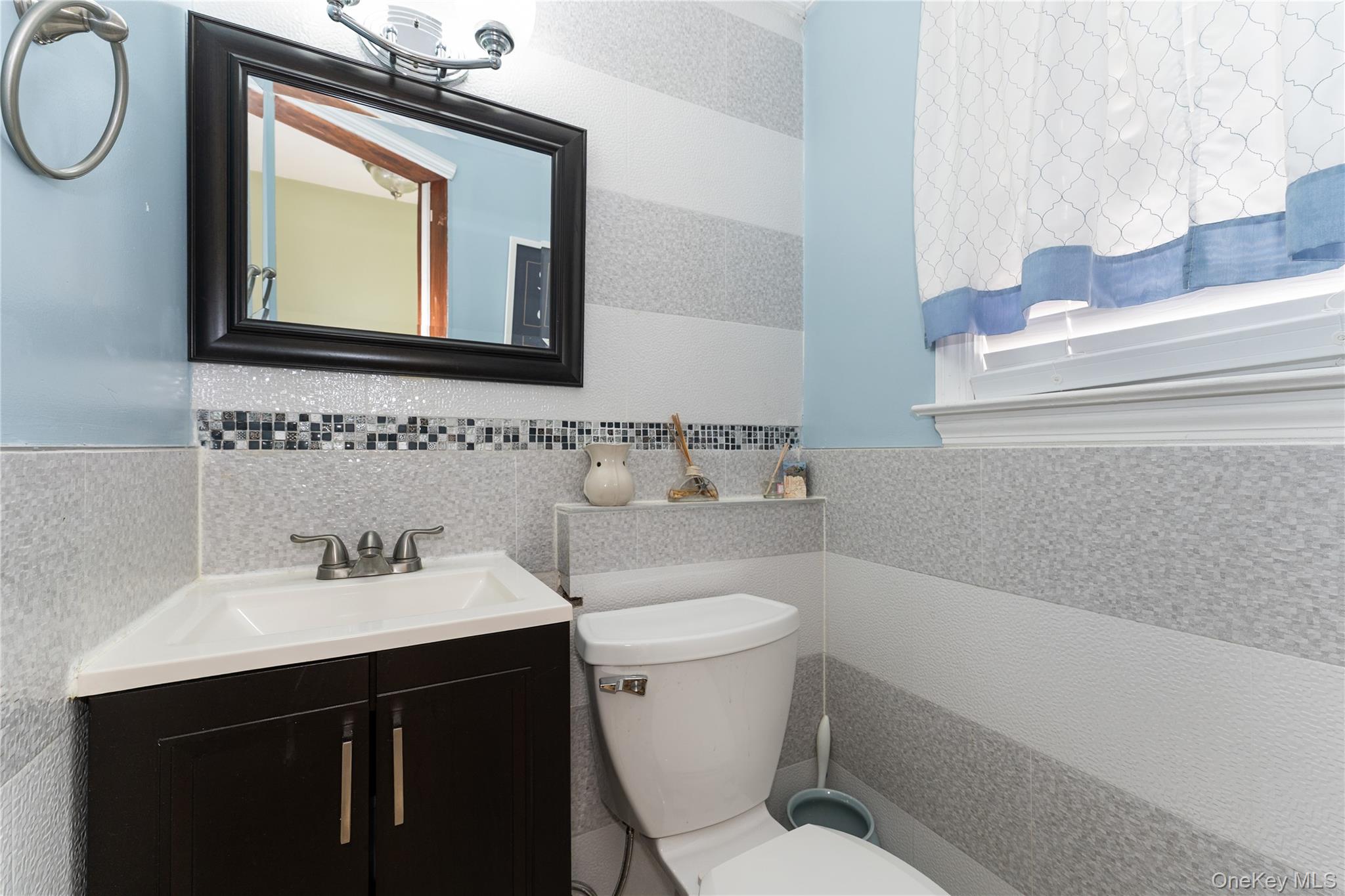 7 Mayfair Road Baldwin, NY 11510 - Photo 17 of 27 a bathroom with a toilet sink and mirror