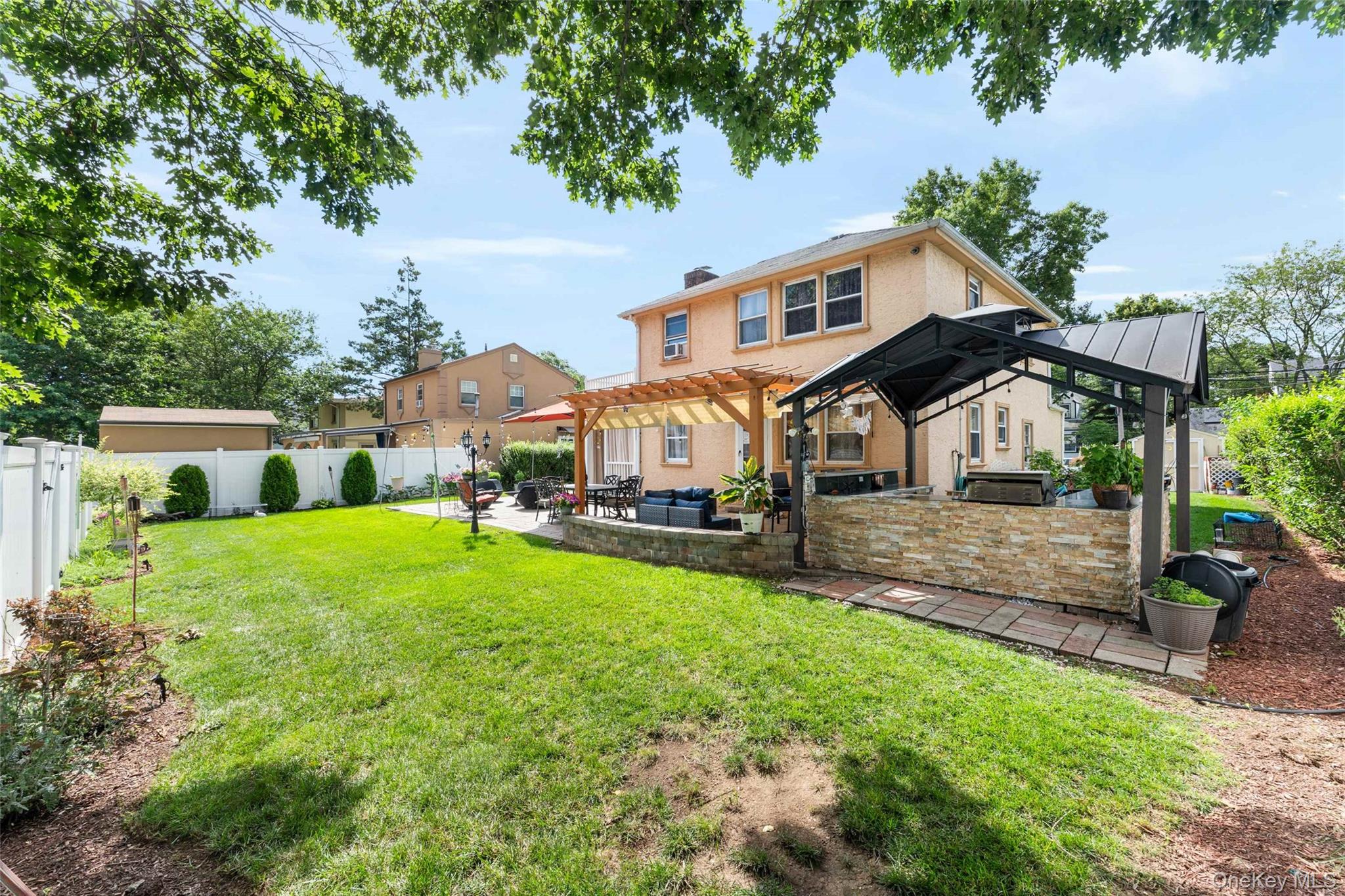 7 Mayfair Road Baldwin, NY 11510 - Photo 20 of 27 a front view of house with yard and trees in the background