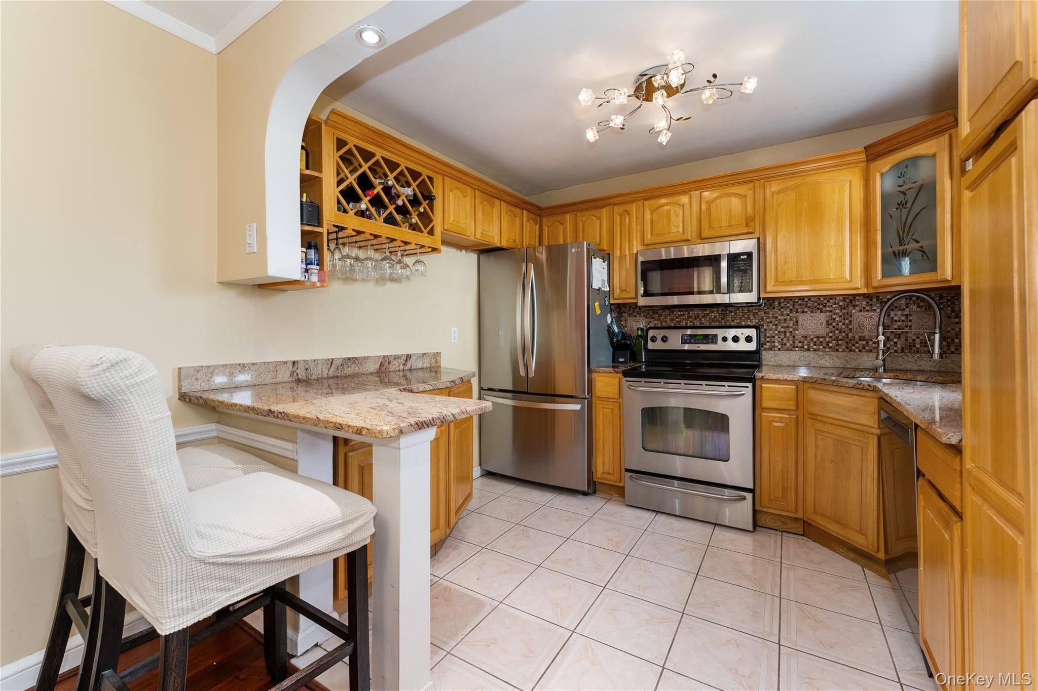 7 Mayfair Road Baldwin, NY 11510 - Photo 8 of 27 a kitchen with a stove a sink and a refrigerator