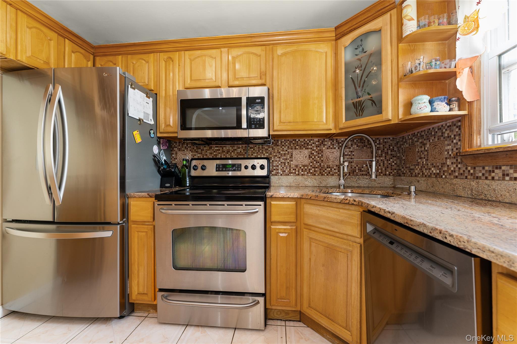 7 Mayfair Road Baldwin, NY 11510 - Photo 9 of 27 a kitchen with stainless steel appliances granite countertop a refrigerator stove and microwave