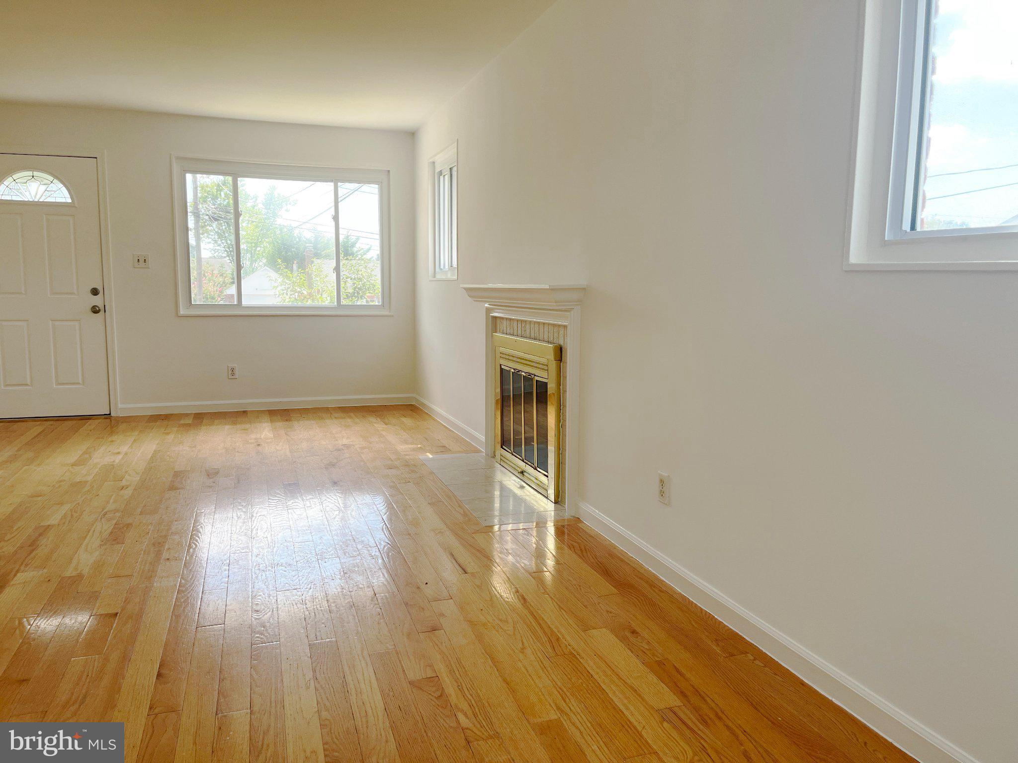 7018 Strathmore Street Falls Church, VA 22042 - Photo 4 of 7 Open living/dining w hardwoods & fireplace