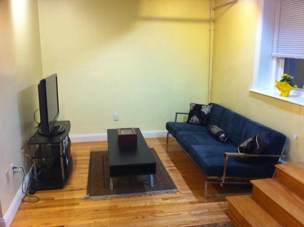 5 Colliston Road, Unit B Boston, MA 02135 - Photo 3 of 9 a living room with furniture and a flat screen tv
