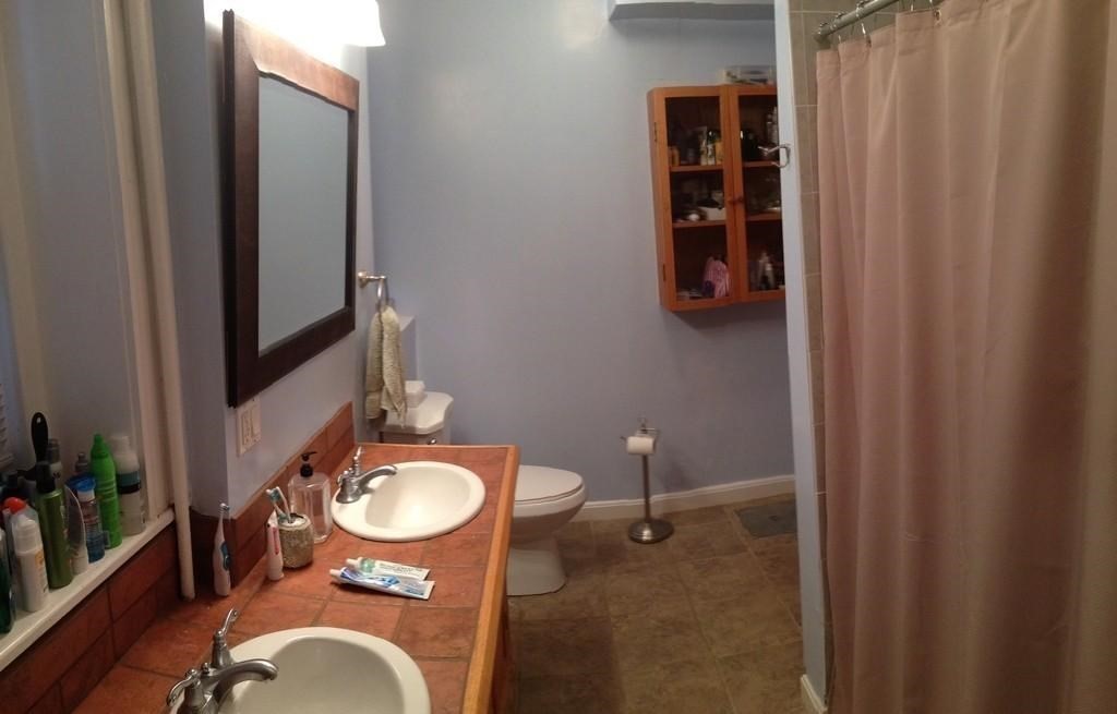 5 Colliston Road, Unit B Boston, MA 02135 - Photo 5 of 9 a bathroom with a toilet a sink and mirror
