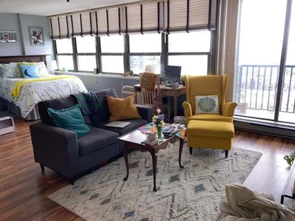 a living room with furniture and large windows