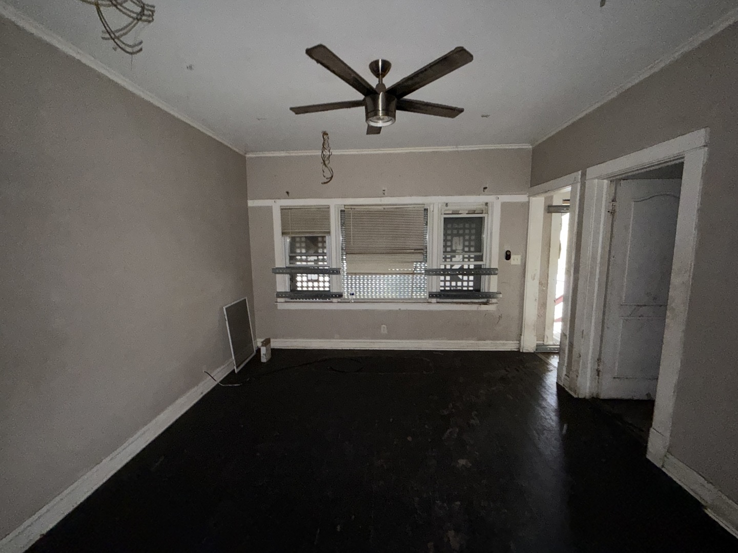 310 West 108th Place Chicago, IL 60628 - Photo 4 of 12 a view of a livingroom with a ceiling fan wooden floor and a ceiling fan