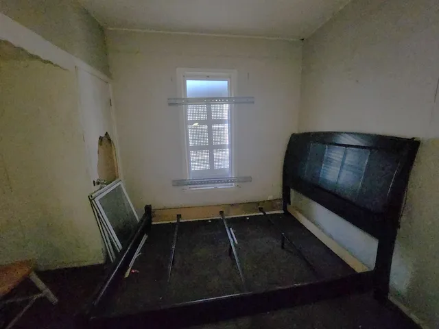 a room with wooden floor and staircase