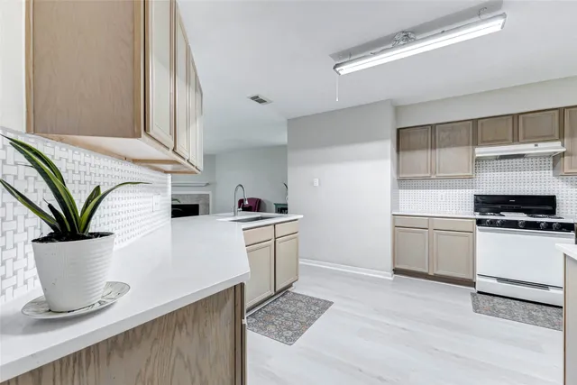 a kitchen with a stove and white cabinets