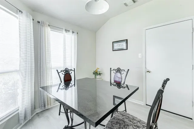 a view of a dining room with furniture and a window