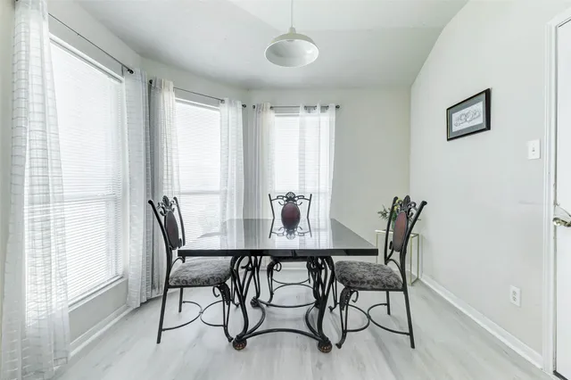 a view of a dining room with furniture and window