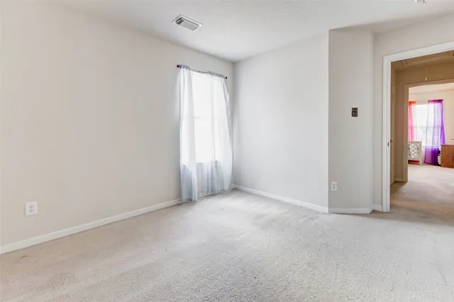 a view of an empty room and closet area