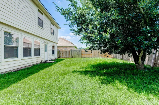 a view of an house with backyard space and garden