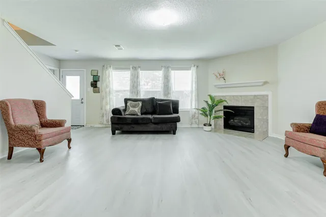 a living room with furniture and a fireplace