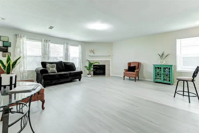 a living room with furniture flat screen tv and a fireplace