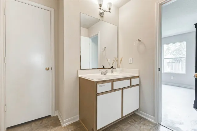 a view of hallway with sink and mirror