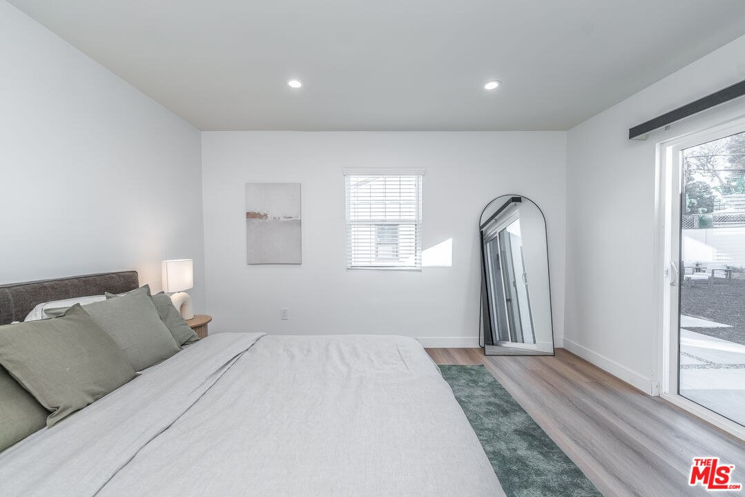 Undisclosed Address Los Angeles, CA 90008 - Photo 12 of 28 a bedroom with a bed and a large window