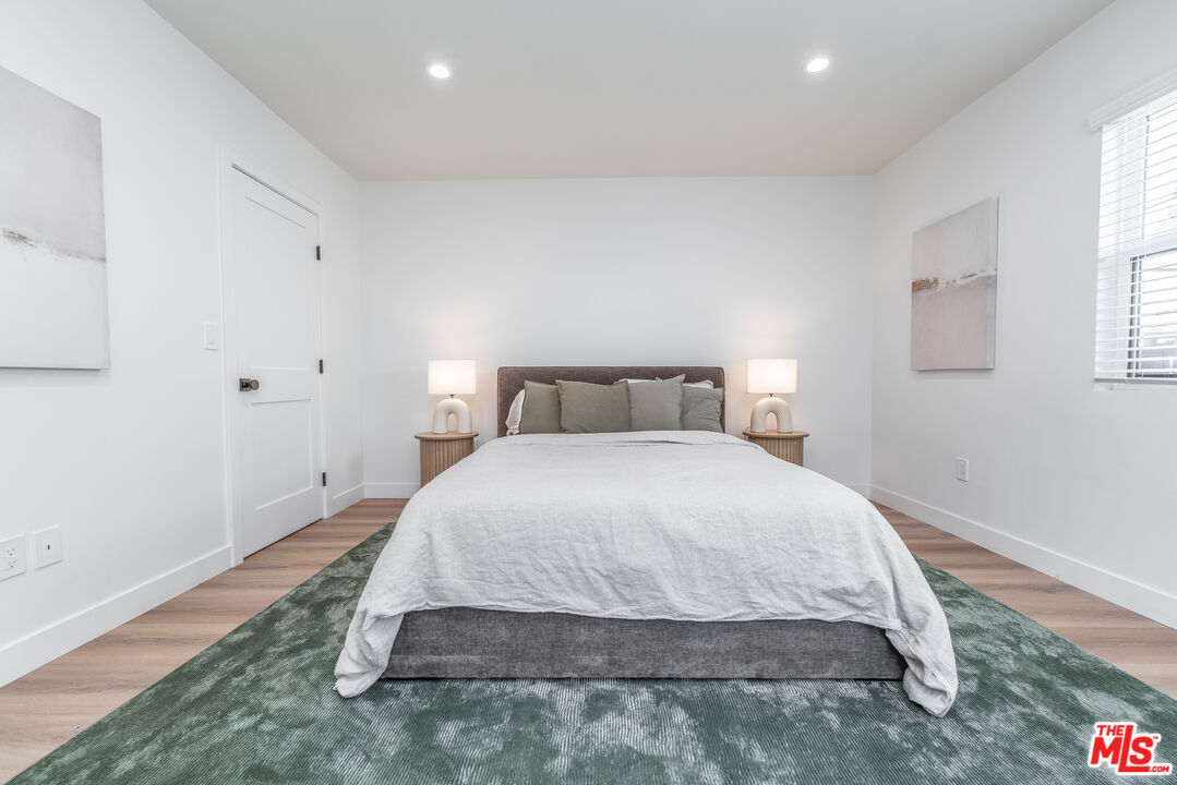 Undisclosed Address Los Angeles, CA 90008 - Photo 14 of 28 a bedroom with a bed and window