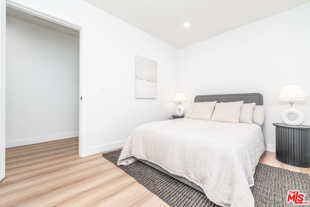 Undisclosed Address Los Angeles, CA 90008 - Photo 17 of 28 a bedroom with a bed and a night stand