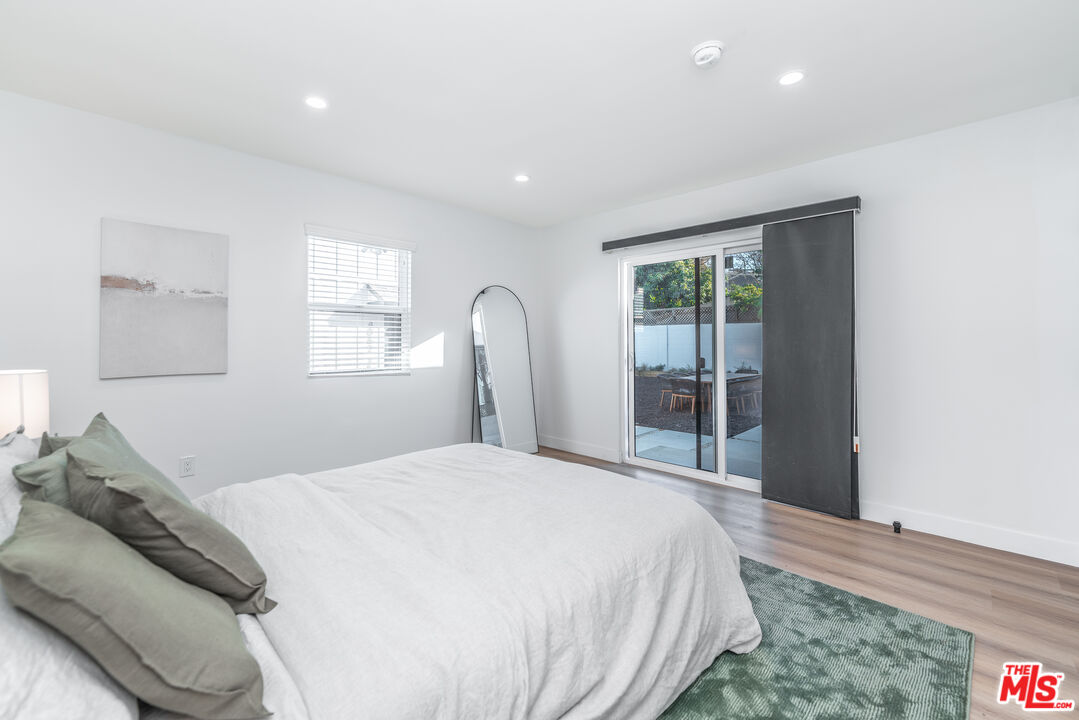 Undisclosed Address Los Angeles, CA 90008 - Photo 19 of 28 a bedroom with a large bed and a large window