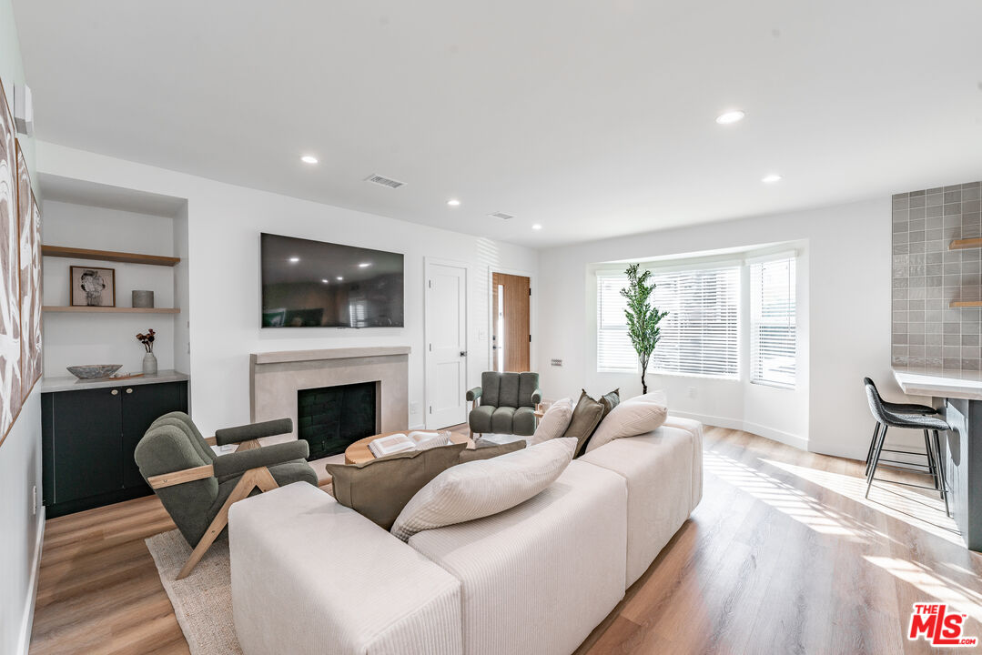 Undisclosed Address Los Angeles, CA 90008 - Photo 5 of 28 a living room with furniture fireplace and window