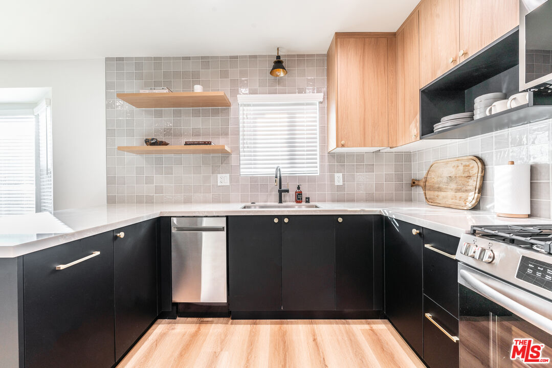 Undisclosed Address Los Angeles, CA 90008 - Photo 9 of 28 a kitchen with a sink a stove and cabinets