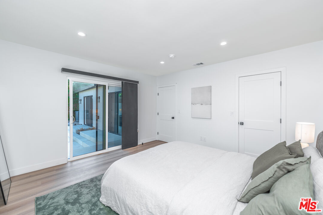 Undisclosed Address Los Angeles, CA 90008 - Photo 10 of 28 a bedroom with a bed and a window