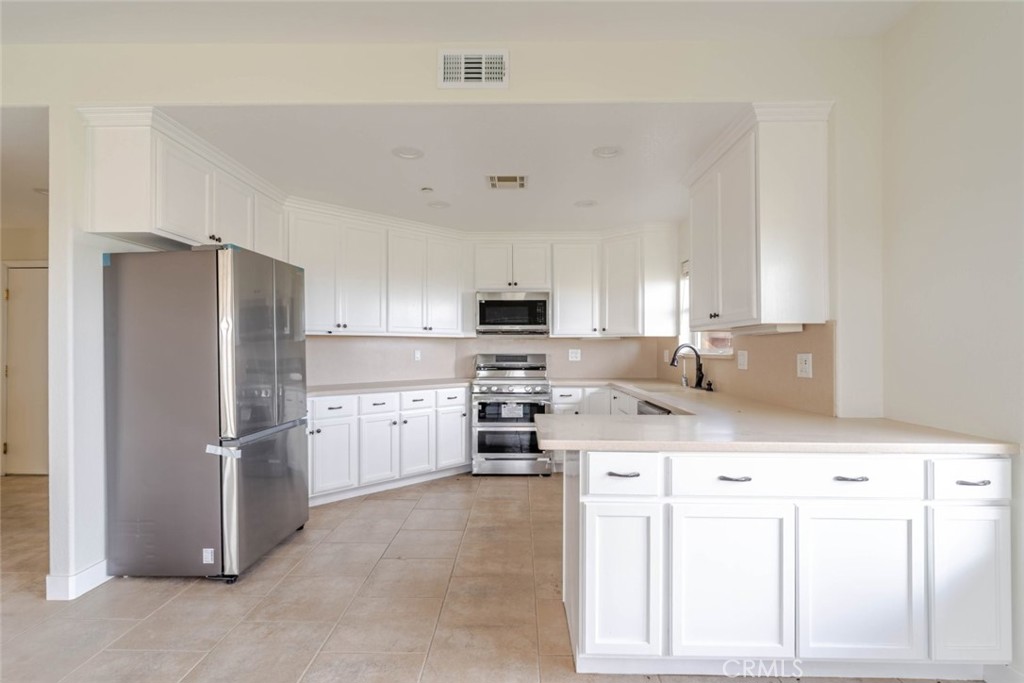 2575 Rale Drive Palmdale, CA 93550 - Photo 12 of 41 a kitchen with stainless steel appliances granite countertop a refrigerator stove and sink
