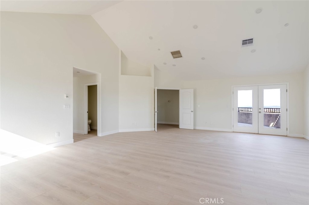 2575 Rale Drive Palmdale, CA 93550 - Photo 18 of 41 a view of an empty room with wooden floor and a window