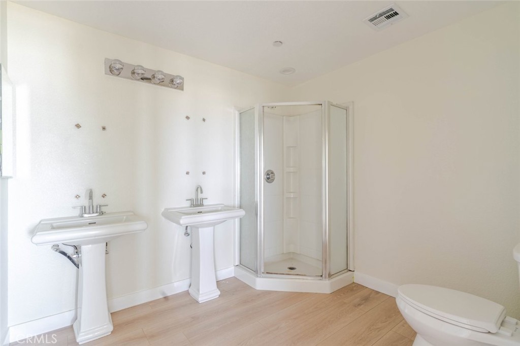 2575 Rale Drive Palmdale, CA 93550 - Photo 21 of 41 a bathroom with a sink a toilet and shower