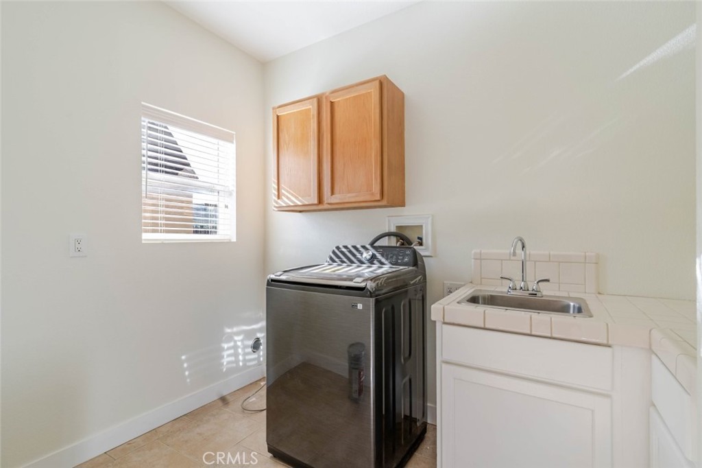 2575 Rale Drive Palmdale, CA 93550 - Photo 24 of 41 a bathroom with a sink a toilet and a window