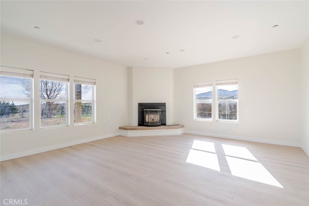 2575 Rale Drive Palmdale, CA 93550 - Photo 3 of 41 an empty room with windows and fireplace
