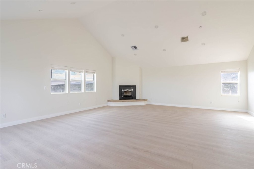 2575 Rale Drive Palmdale, CA 93550 - Photo 7 of 41 a view of an empty room with a window and a kitchen