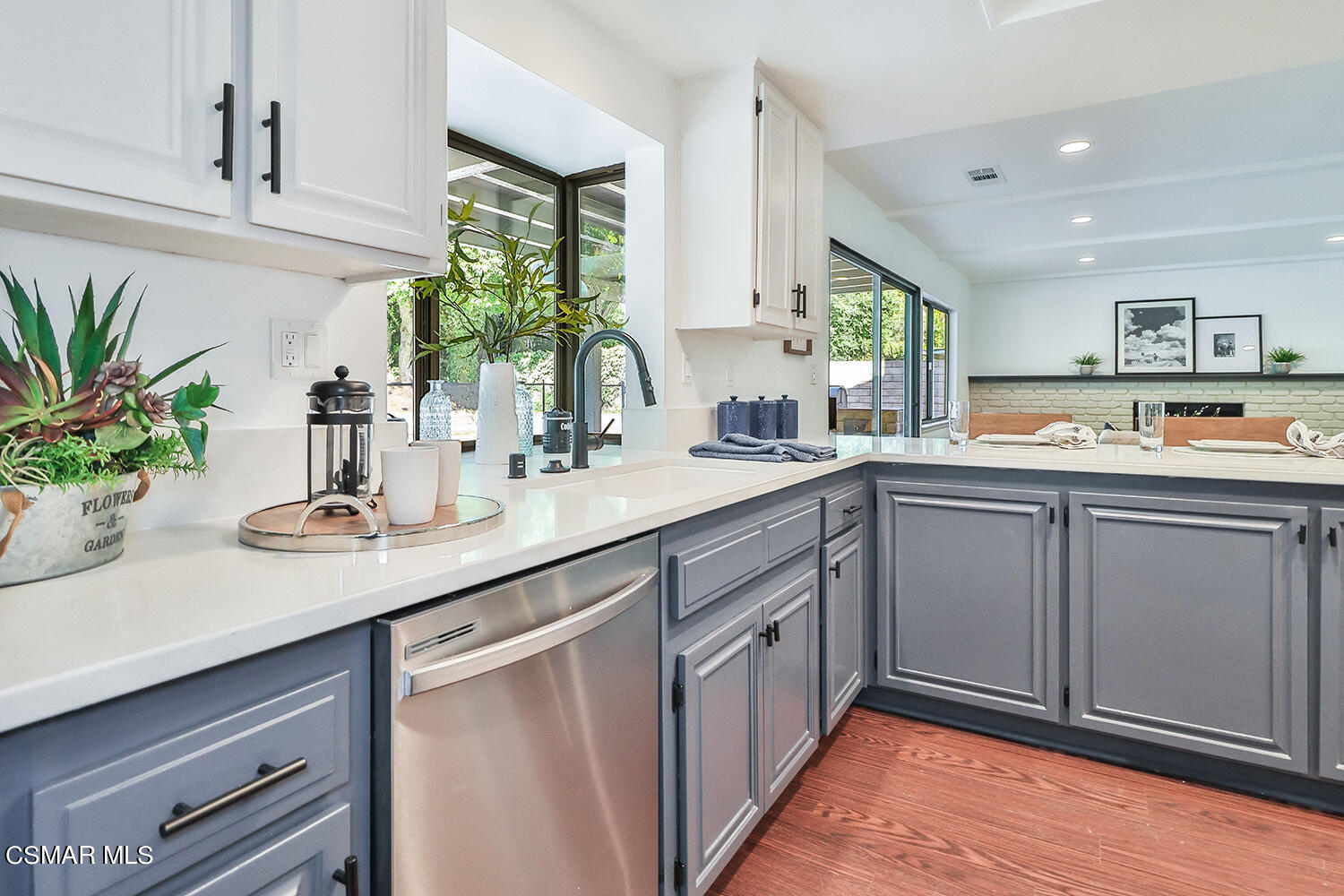 3091 Omega Avenue Simi Valley, CA 93063 - Photo 32 of 66 a kitchen with cabinets a sink and potted plant