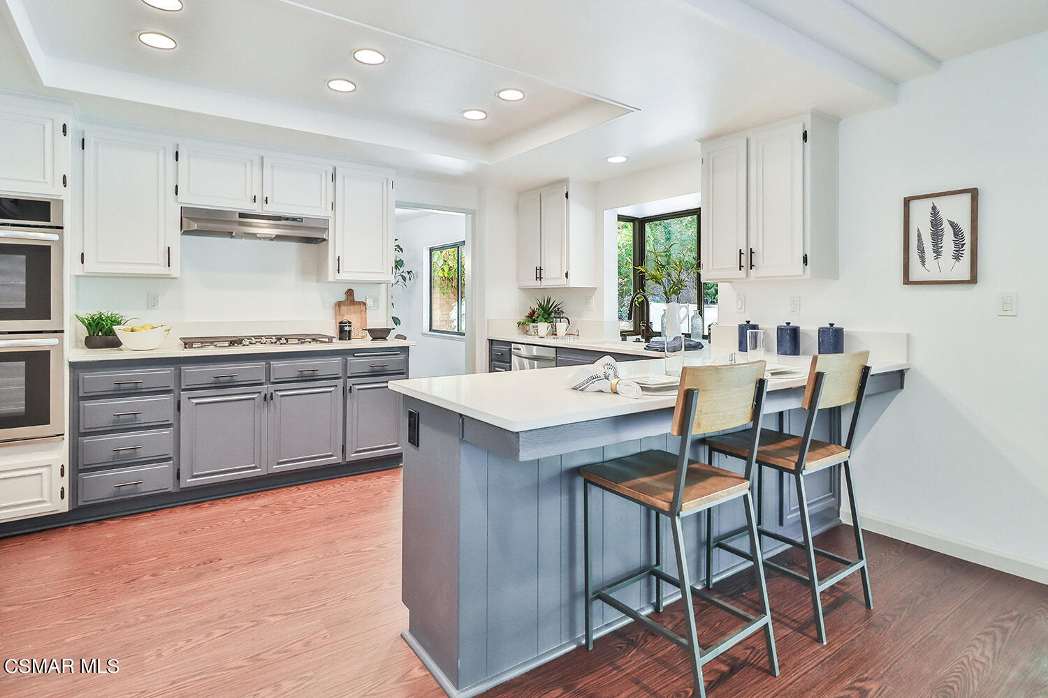 3091 Omega Avenue Simi Valley, CA 93063 - Photo 7 of 66 a kitchen with a stove a sink a dining table and chairs