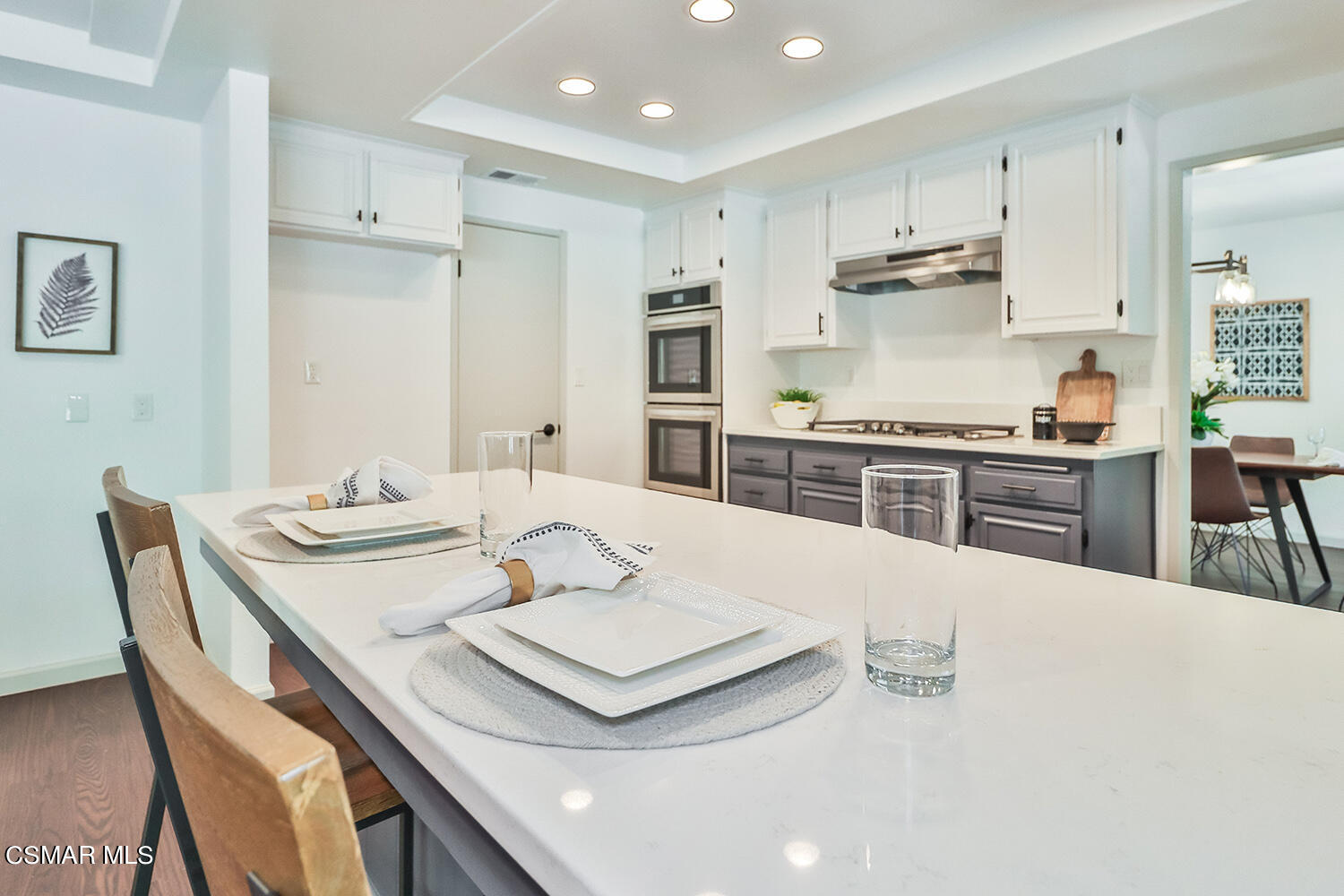 3091 Omega Avenue Simi Valley, CA 93063 - Photo 8 of 66 a kitchen with kitchen island a stove a table and chairs