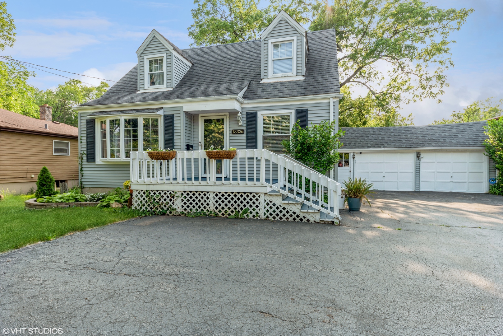 a view of a house with a yard and deck