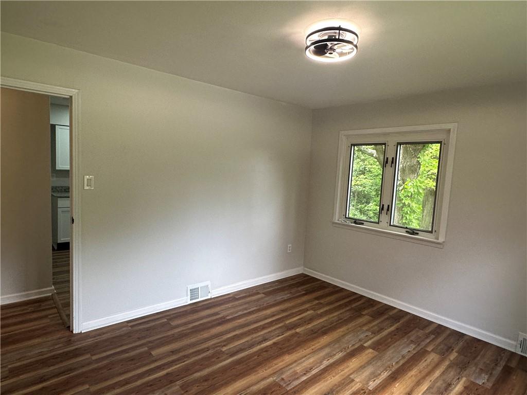 201 Clever Road McKees Rocks, PA 15136 - Photo 17 of 30 an empty room with wooden floor cabinet and windows
