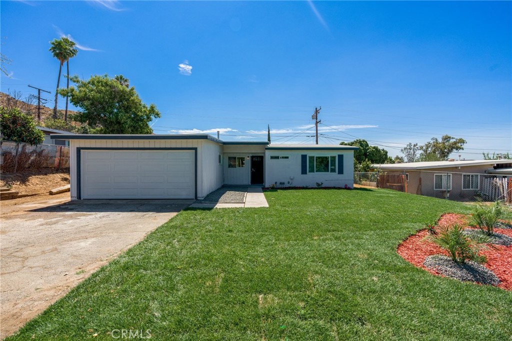 3254 Laurel Drive Riverside, CA 92509 - Photo 2 of 26 a front view of a house with a yard and garage