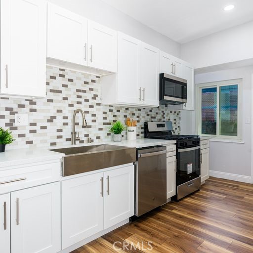 3254 Laurel Drive Riverside, CA 92509 - Photo 9 of 26 a kitchen with stainless steel appliances white cabinets and a sink