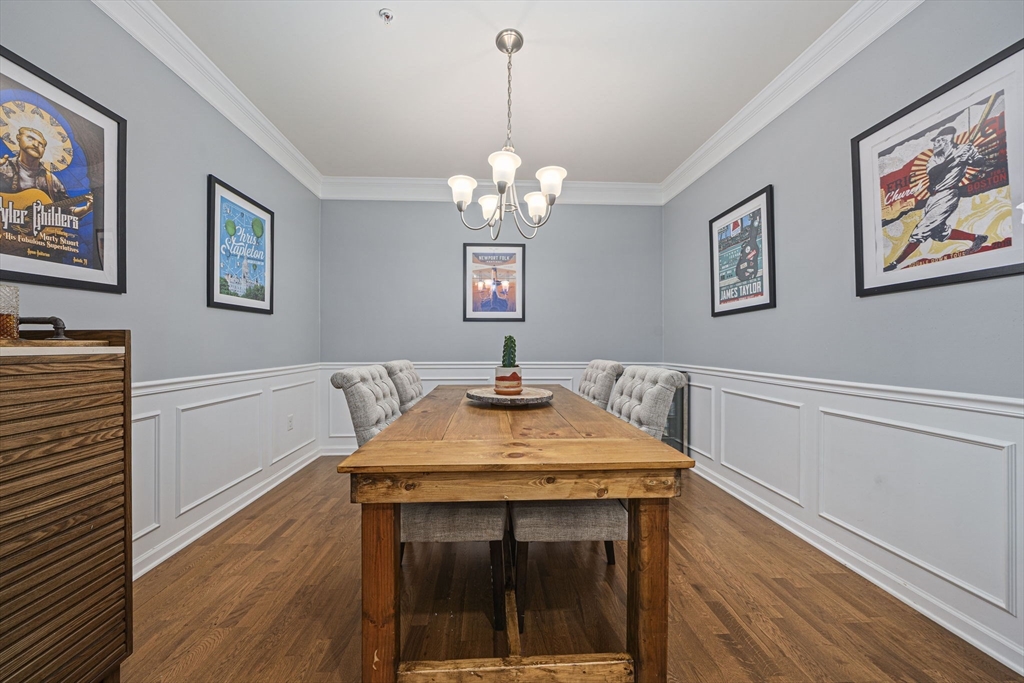 70 Trotter Road, Unit 310 Weymouth, MA 02190 - Photo 4 of 14 a view of a dining room with furniture wooden floor and a chandelier