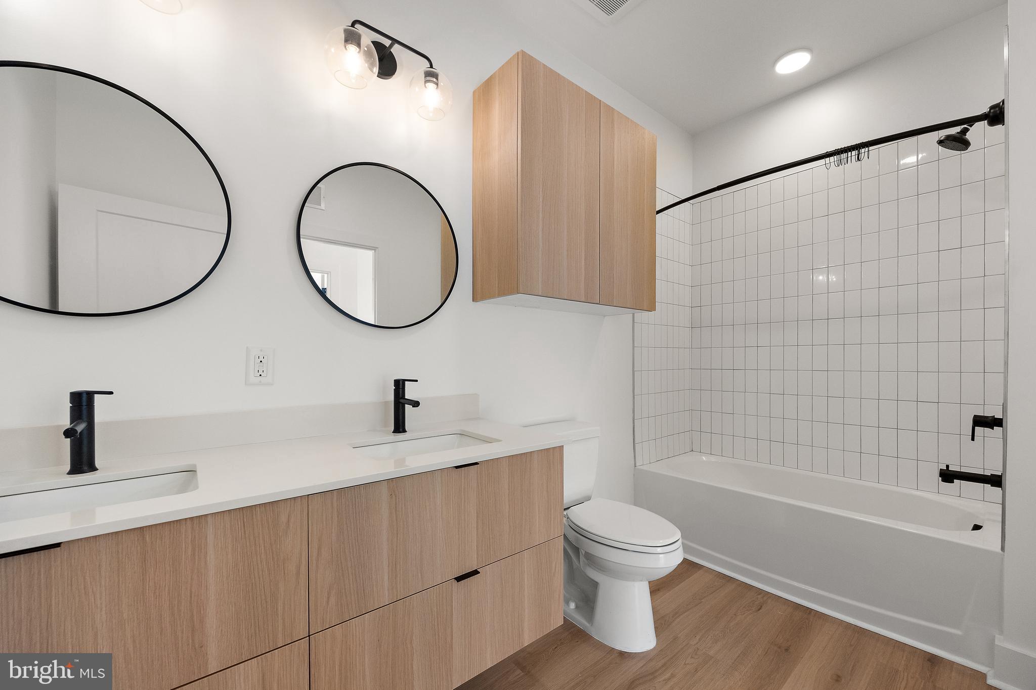 801 North Market Street, Unit 305 Wilmington, DE 19801 - Photo 4 of 11 a bathroom with a toilet a sink and a mirror