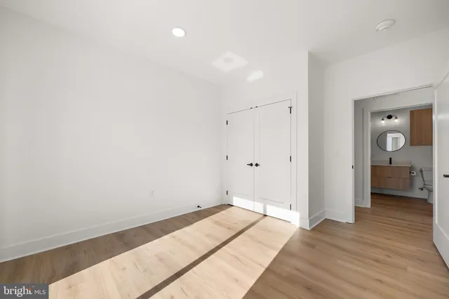 a view of a room with wooden floor and bathroom
