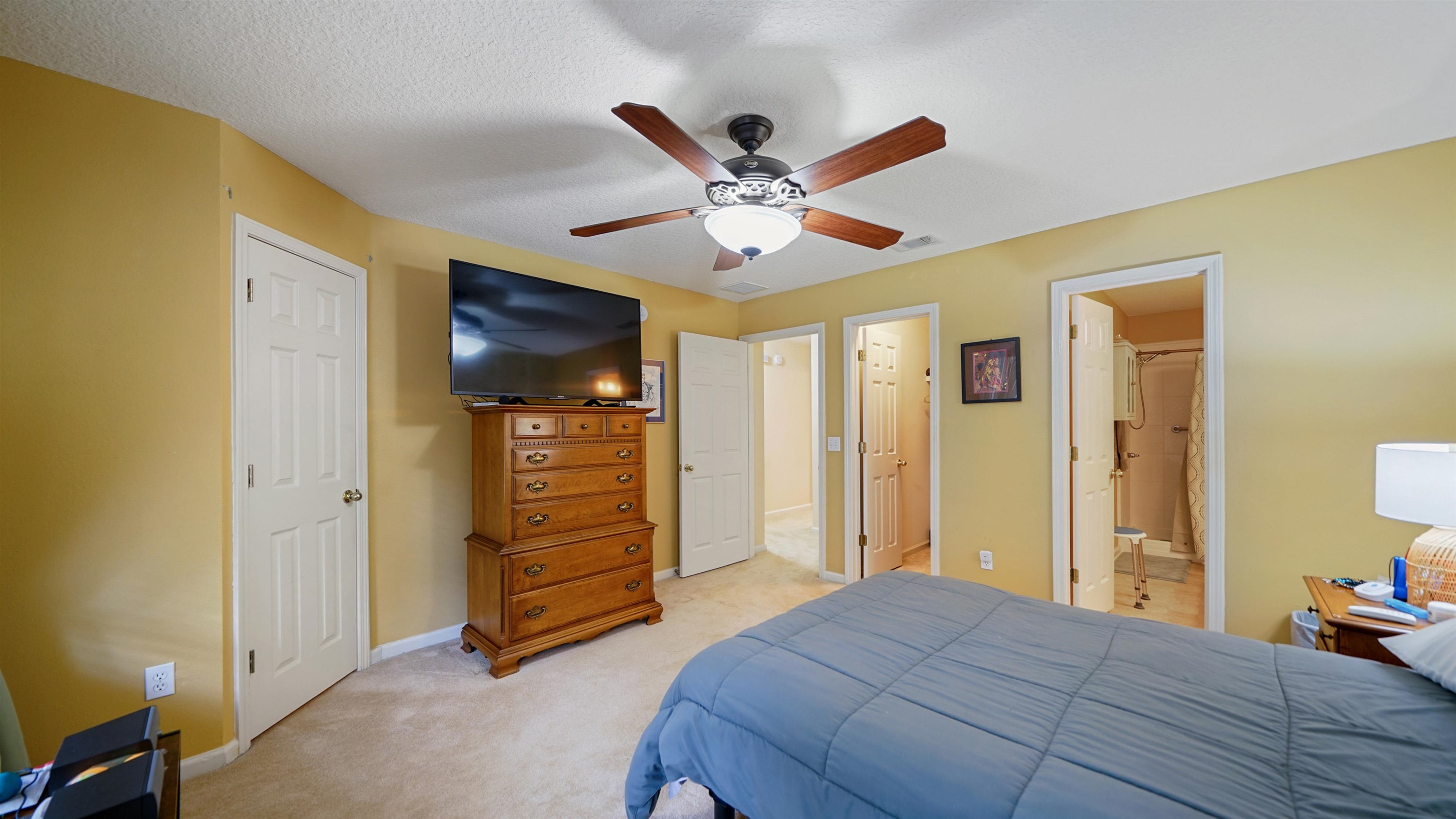 875 Scrub Jay Drive St. Augustine, FL 32092 - Photo 11 of 28 a bedroom with a bed and a ceiling fan